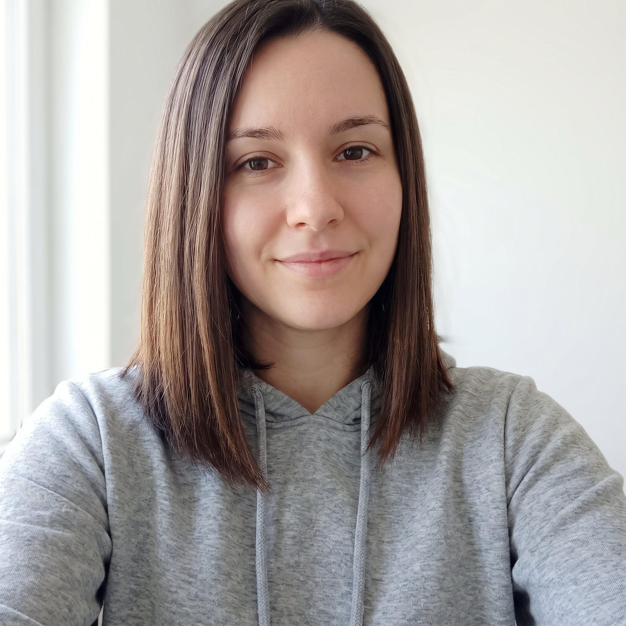 files/Woman_smiling_in_gray_hoodie_202608110505.jpg